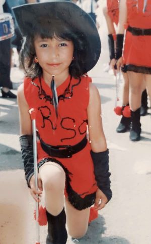 Young Lideny Andino dressed in her red baton twirler uniform for an Independence Day celebration in Honduras.