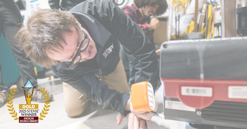 An energy expert measures motor speed using a special device.