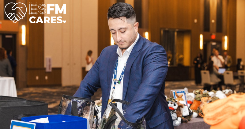 An ESFM team member gets hands-on, assembling care kits for veterans for a service project.