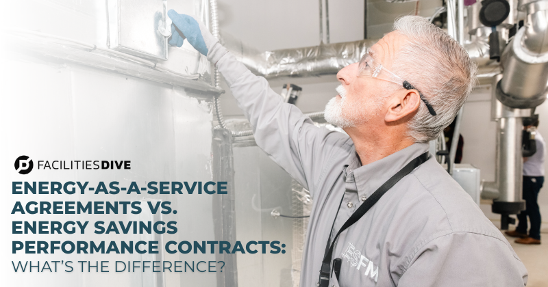 A hard services team member inspects a facility's HVAC system.